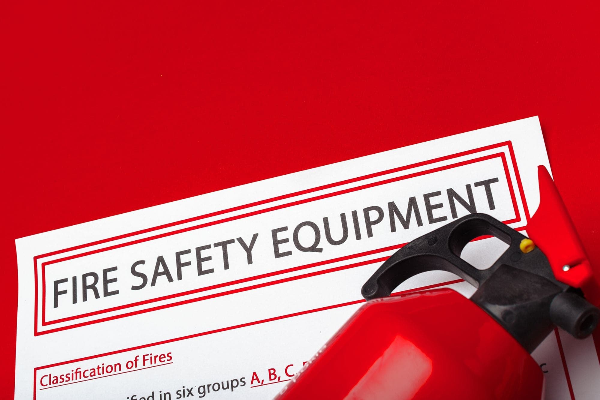 Close up photograph of an inspection record tag on a fire extinguisher.